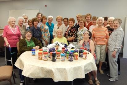 Members of the Miriam Circle celebrate the collection of 68 pairs of socks and 57 items for the Food Pantry and Health Kits at their September Meeting.